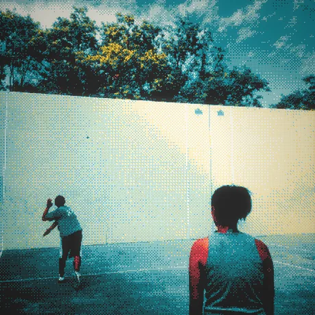 Two kids playing handball against a court wall, halftoned in teal and cream.